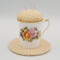 This is a frontal view of the teacup pincushion and trivet. The peonies are really pretty.